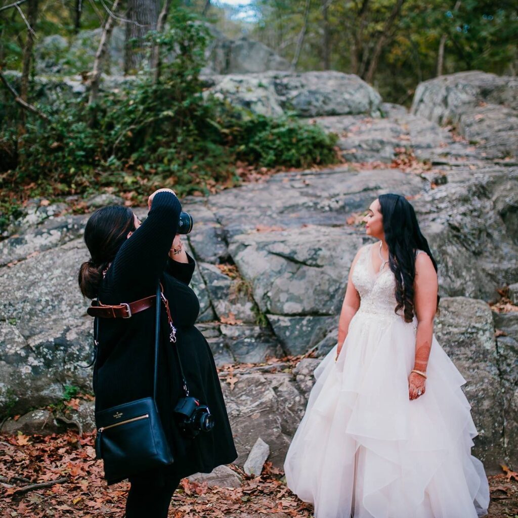 Photographer taking a portrait of a bride in the forest